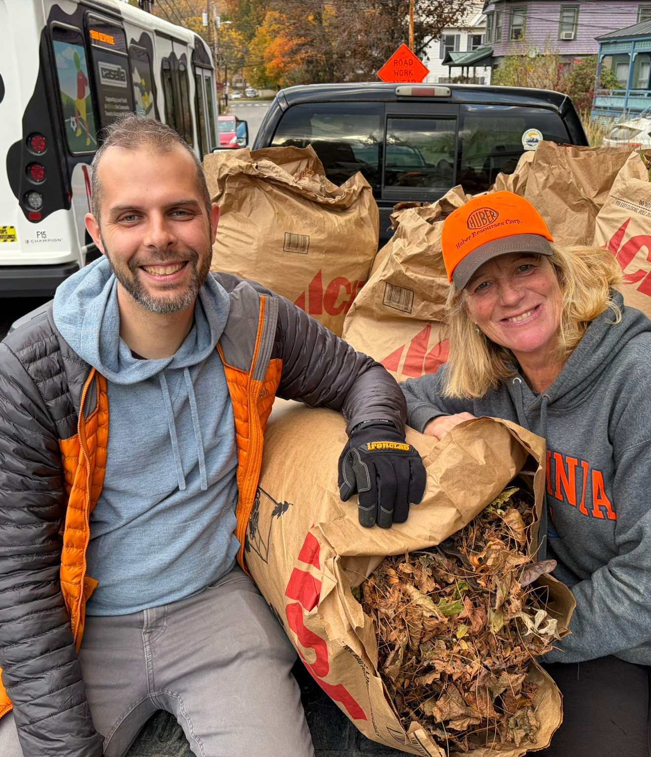 Oscar and Amanda loading leaves into a truck.